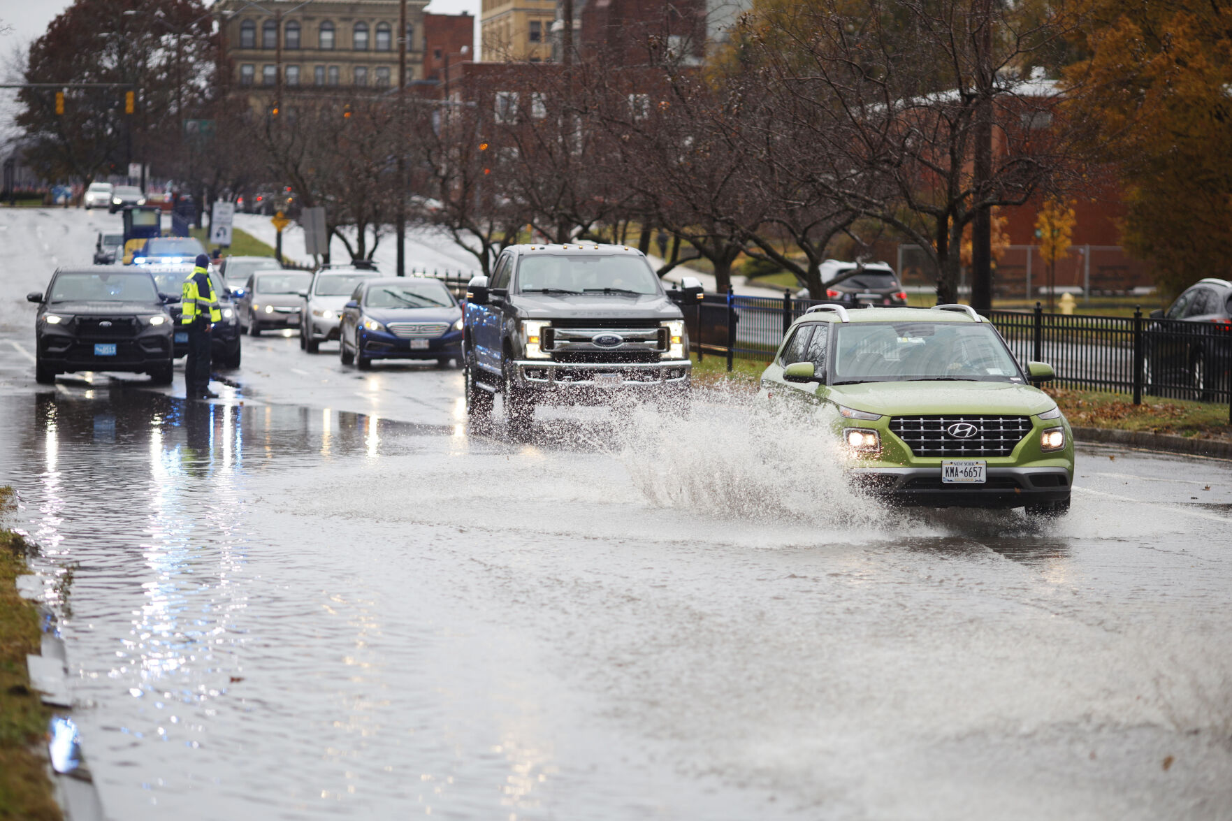 cars splash through flooding